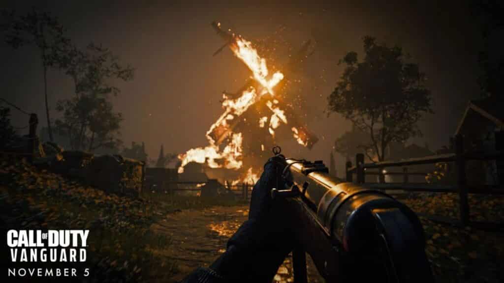 arthur kingsley holding mp-40 looking at burning windmill