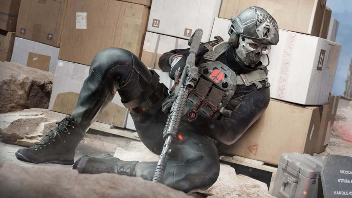 warzone operator hiding behind cover with gun in hand